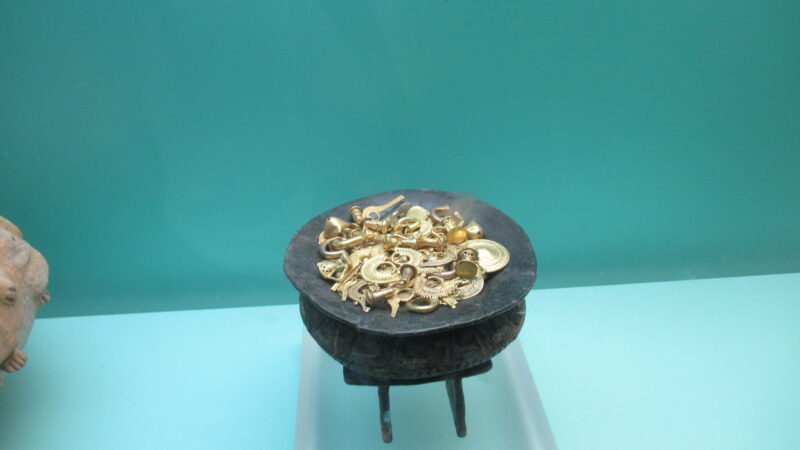 A bowl holding examples of gold artifacts on display in the Museo del Oro in Cartagena.