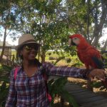 Susana with a parrot on her arm.