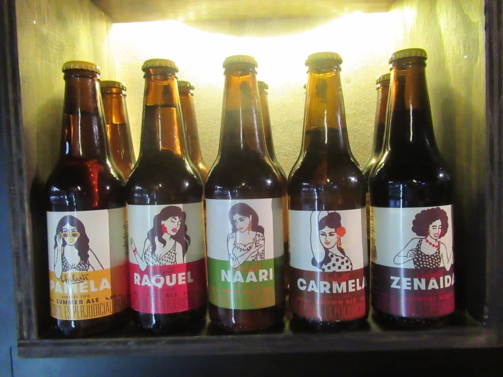 Photo of the bottles of 5 Chelarte Colombian craft beer styles, showing the label of each with the woman's picture.