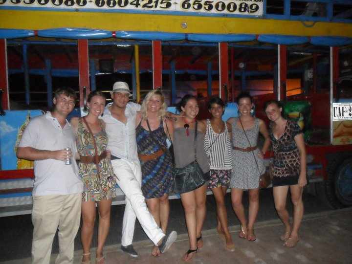 Photo of some people standing in front of a chiva bus a fun Cartagena Colombia what to do.