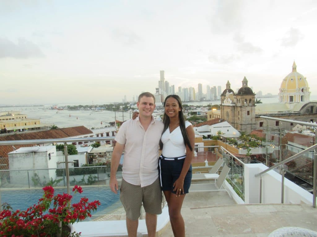 Adam and Susana standing atop Hotel Movich at the rooftop bar one of the things to do in Cartagena Colombia.