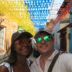 Photo of a girl and guy in the street of Cartagena, Colombia with Colombia flag pennants above.