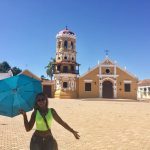 Photo of a girl standing in front of a church