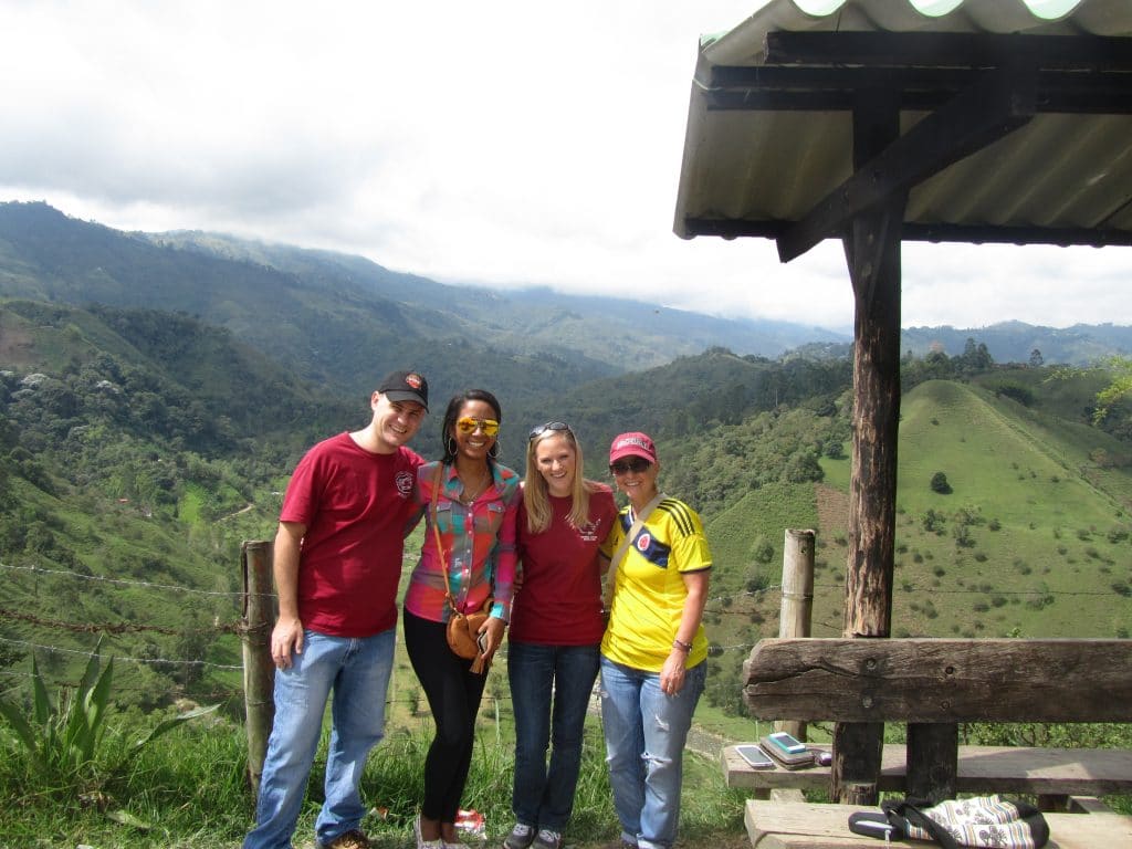 Photo of 4 people standing overlooking the hills in Salento, Colombia