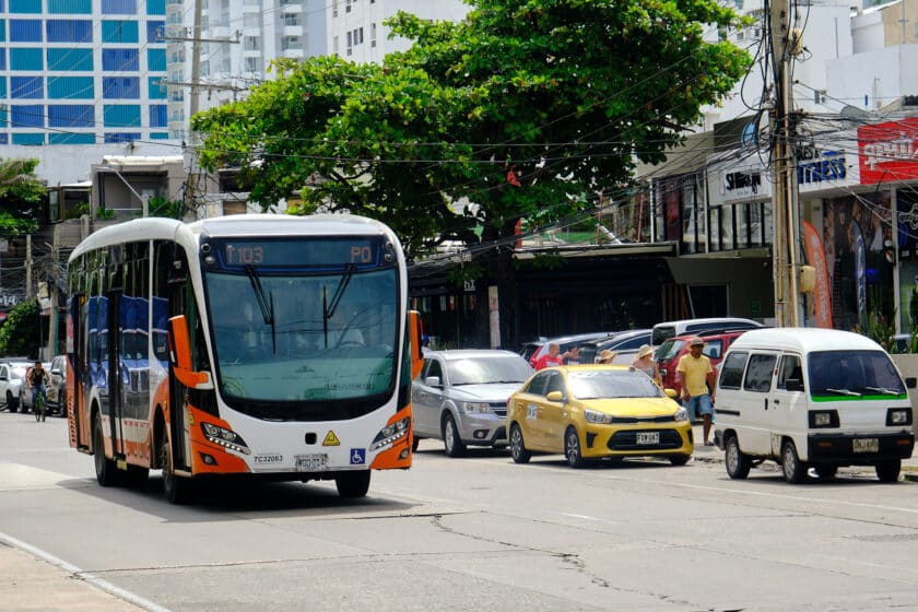 A bus and taxi providing Cartagena public transportation in the street.