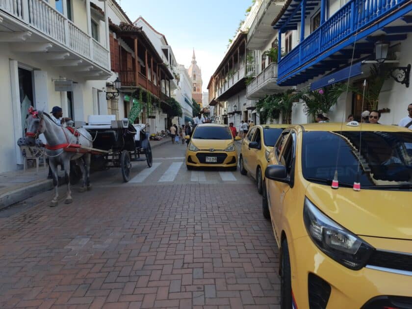 Taxis parked in a street waiting to provide a way for how to get around Cartagena, Colombia.
