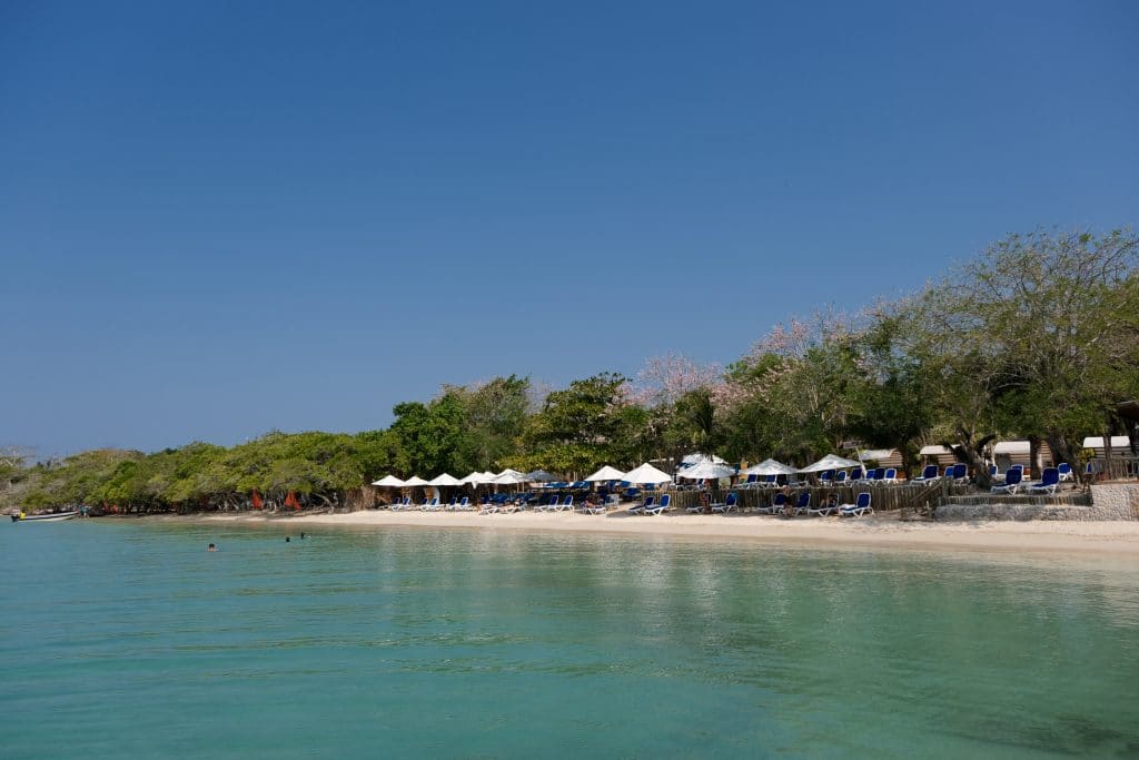 Photo of the beach area at the Isla del Encanto Cartagena showing the water and chairs on the beach.