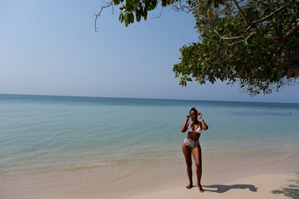 Photo of a girl under a tree with the beach behind her at the Hotel Isla del Encanto Barú