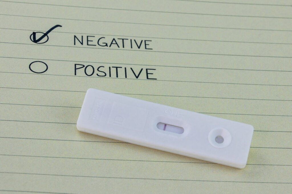 Photo of a test strip with a check mark next to negative on a piece of paper, like what you hope to get at the places that do Covid testing in Cartagena.