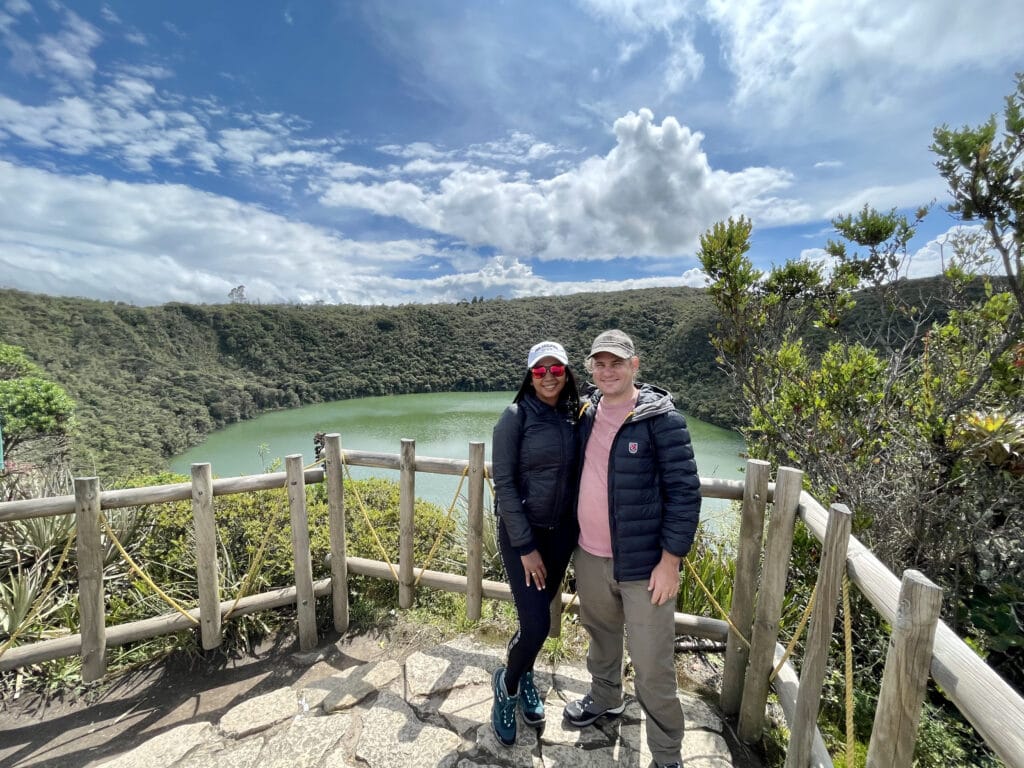 Photo of a couple with the Laguna Guatavita behind them.