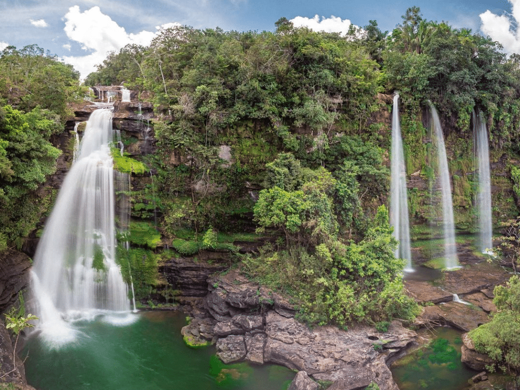 Photo of a big waterfall on the left with 3 thinner falls on the right.