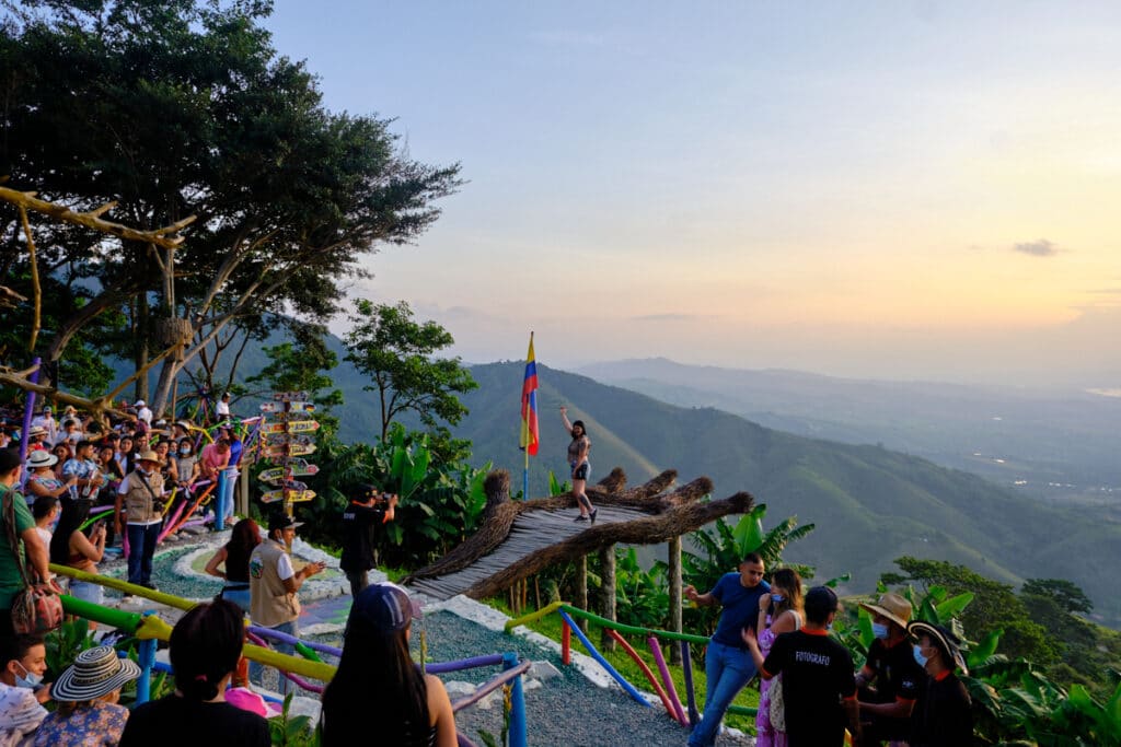 Photo of the Mano del Gigante in Huila with a girl posing and crowd around.