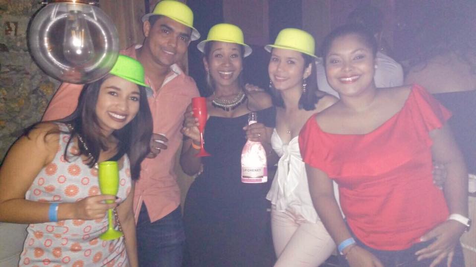 Photo of a group of people in plastic party hats enjoying Cartagena nightlife.