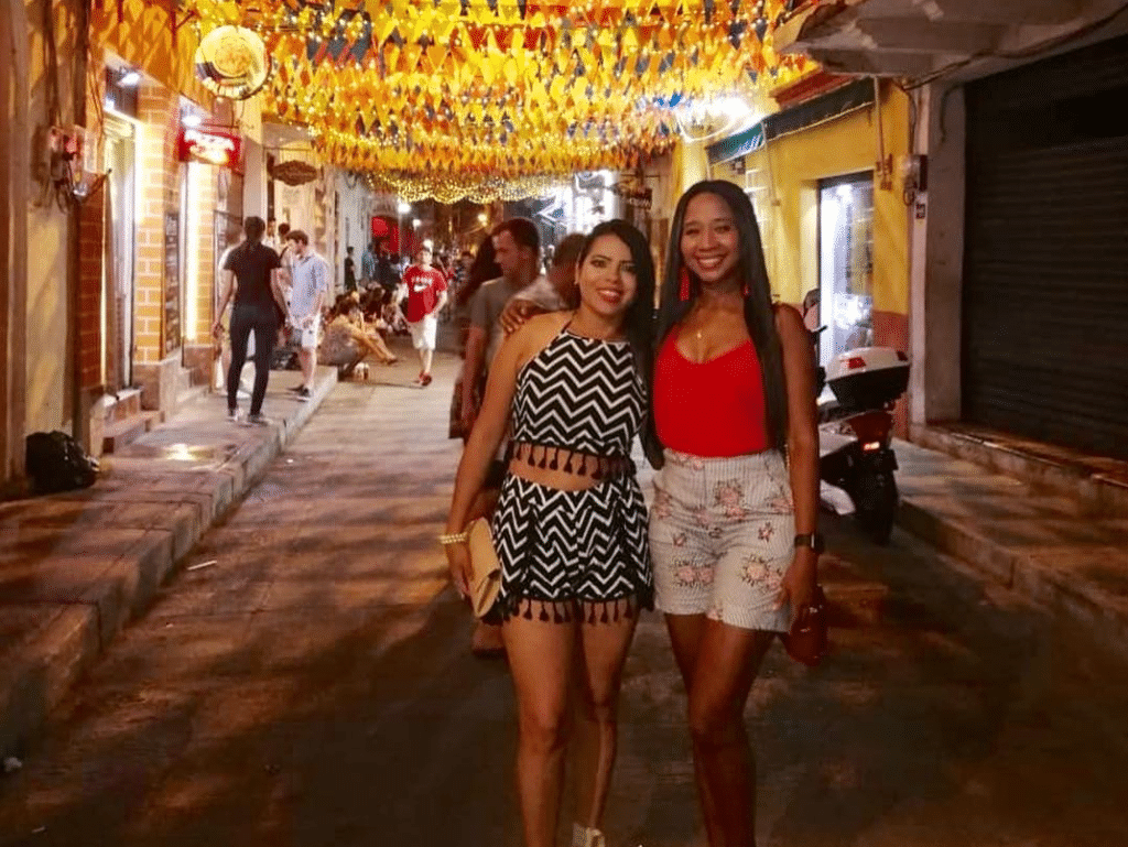 Photo of two girls in the street enjoying the nightlife in Cartagena Colombia.