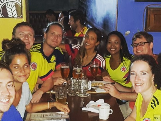 Photo of people at a table with beers enjoying the Colombia Cartagena nightlife.