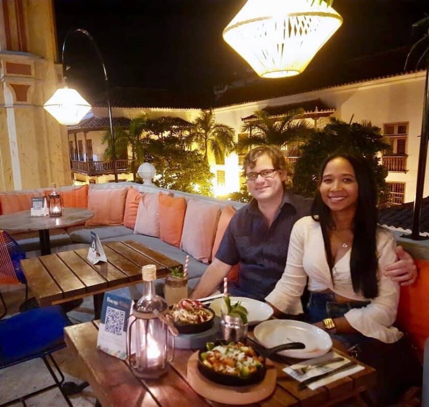 Photo of a couple at a table with food at the Buena Vida Rooftop in Cartagena, Colombia.