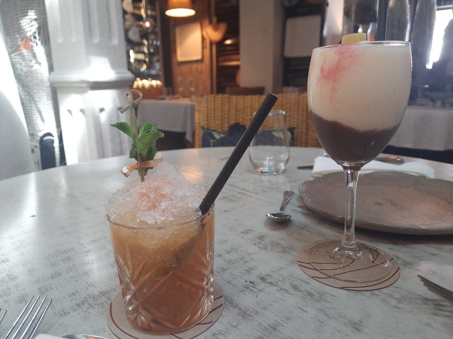 A short glass and taller glass on a table.