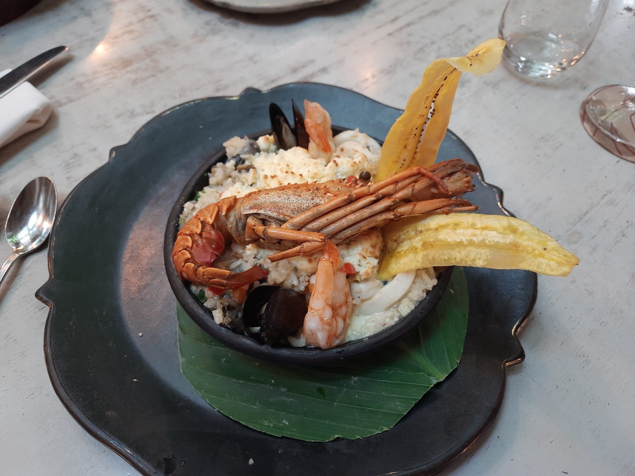 Rice with seafood in a bowl on a table.