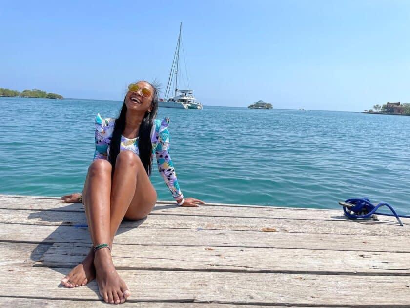 Girl on a dock laughing and enjoying her 4 day Cartagena itinerary.