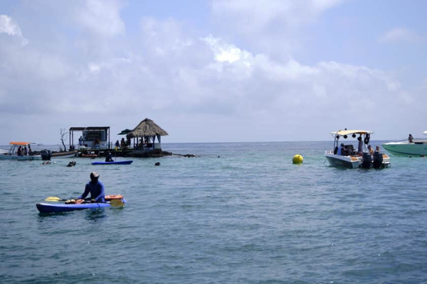People on Cartagena boats for hire pulled up near La Piscina.