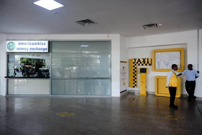 A money exchange window and kiosk for getting the cost of a taxi from Cartagena airport to old town or other places.