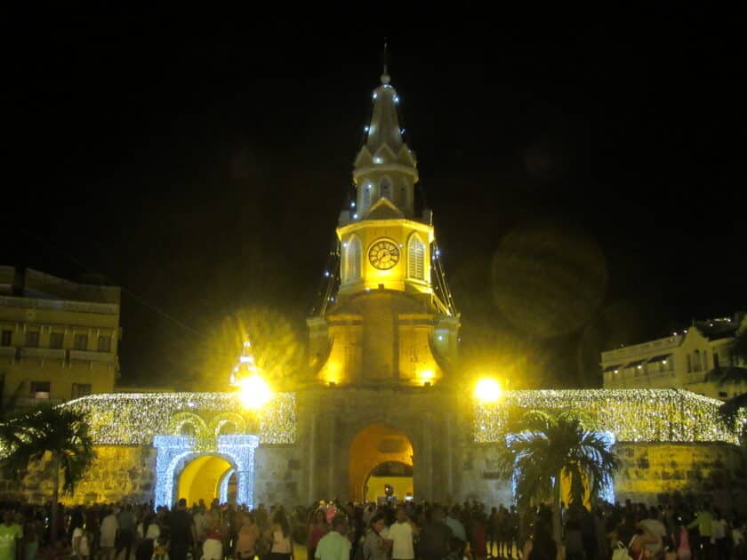Clocktower with Christmas lights and lots of people standing in front for Cartagena New Year's Eve.